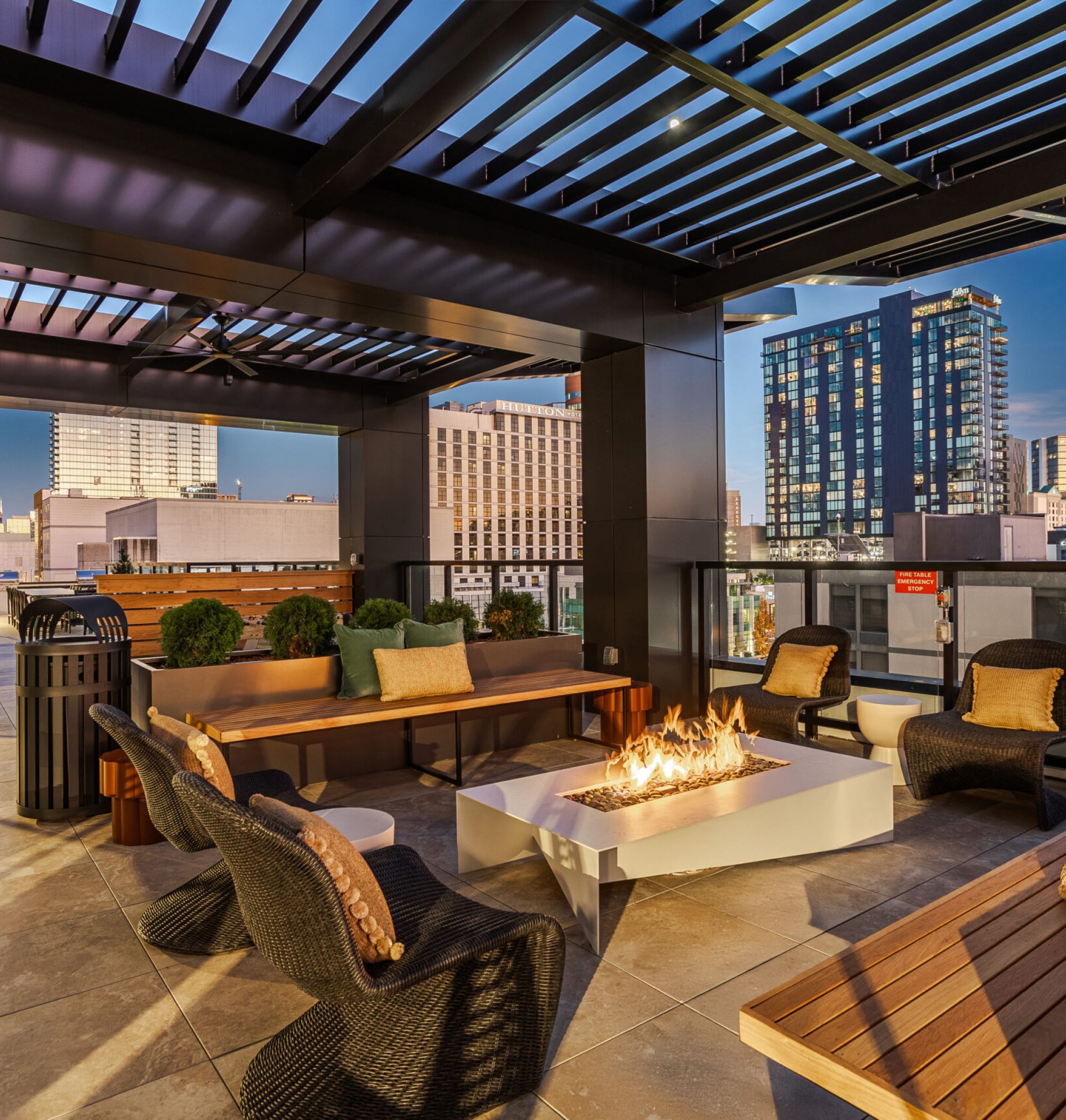 LOCAL Nashville Apartments covered pool deck with bocce ball court, lounge seating, and beautiful landscaping