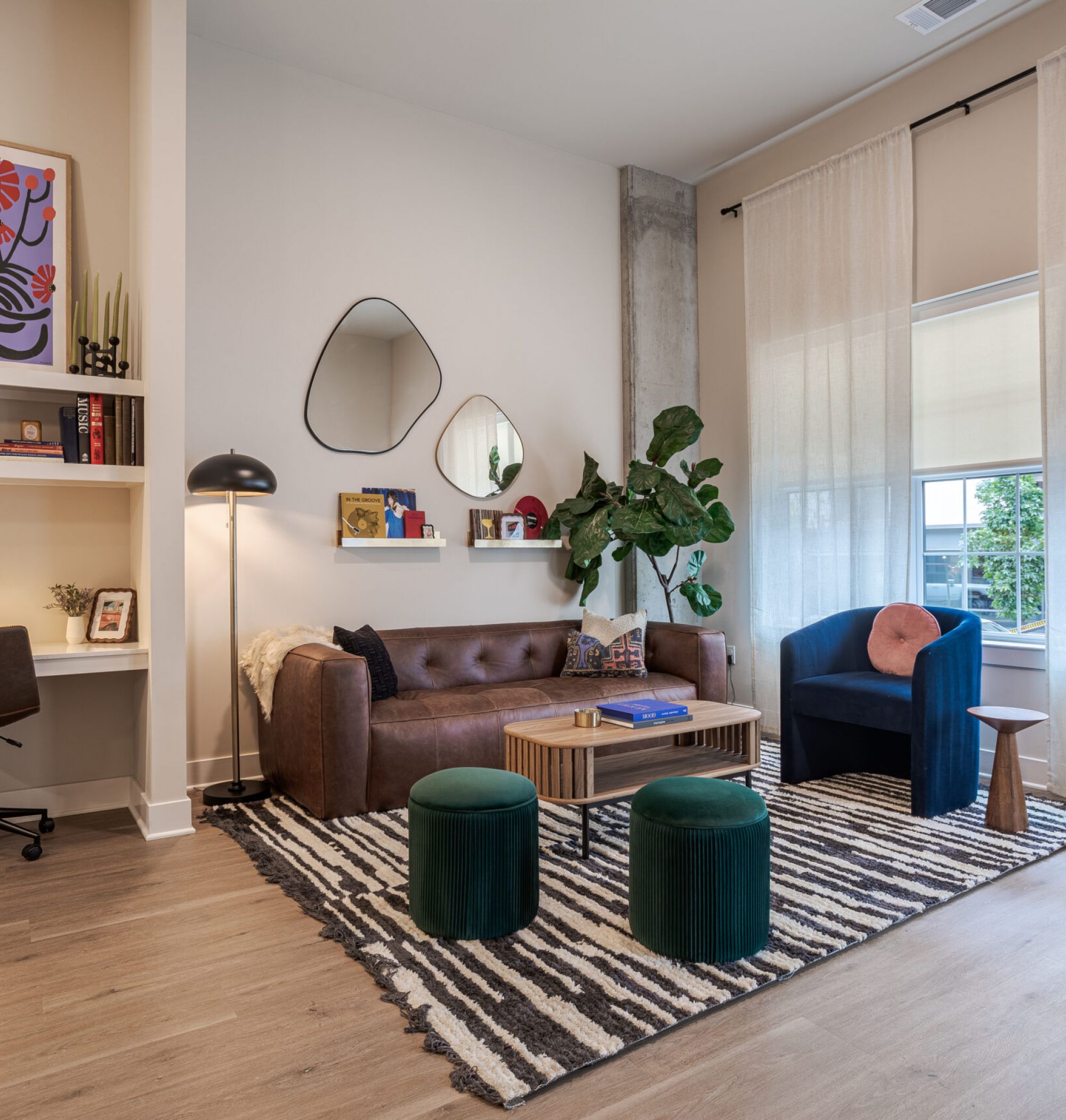 LOCAL Nashville Apartments furnished living room with a modern leather couch and seating