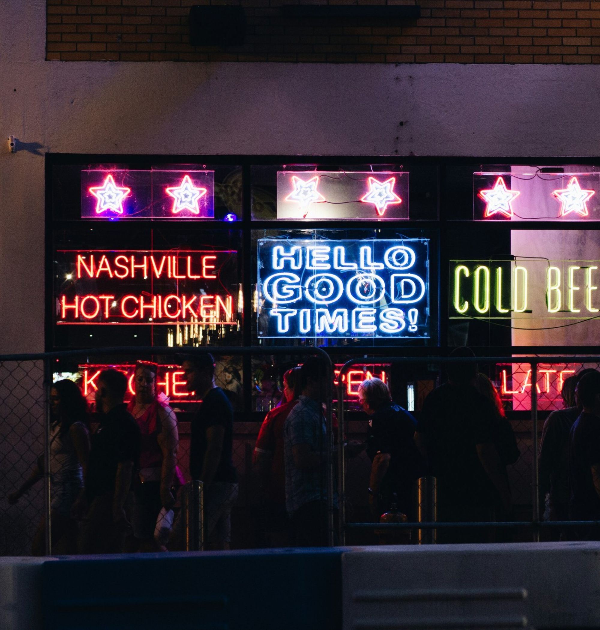 Neon signs lit up in the window of a bar and grill in Nashville, TN