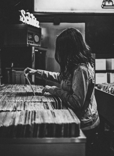 Woman shopping for records in a record shop
