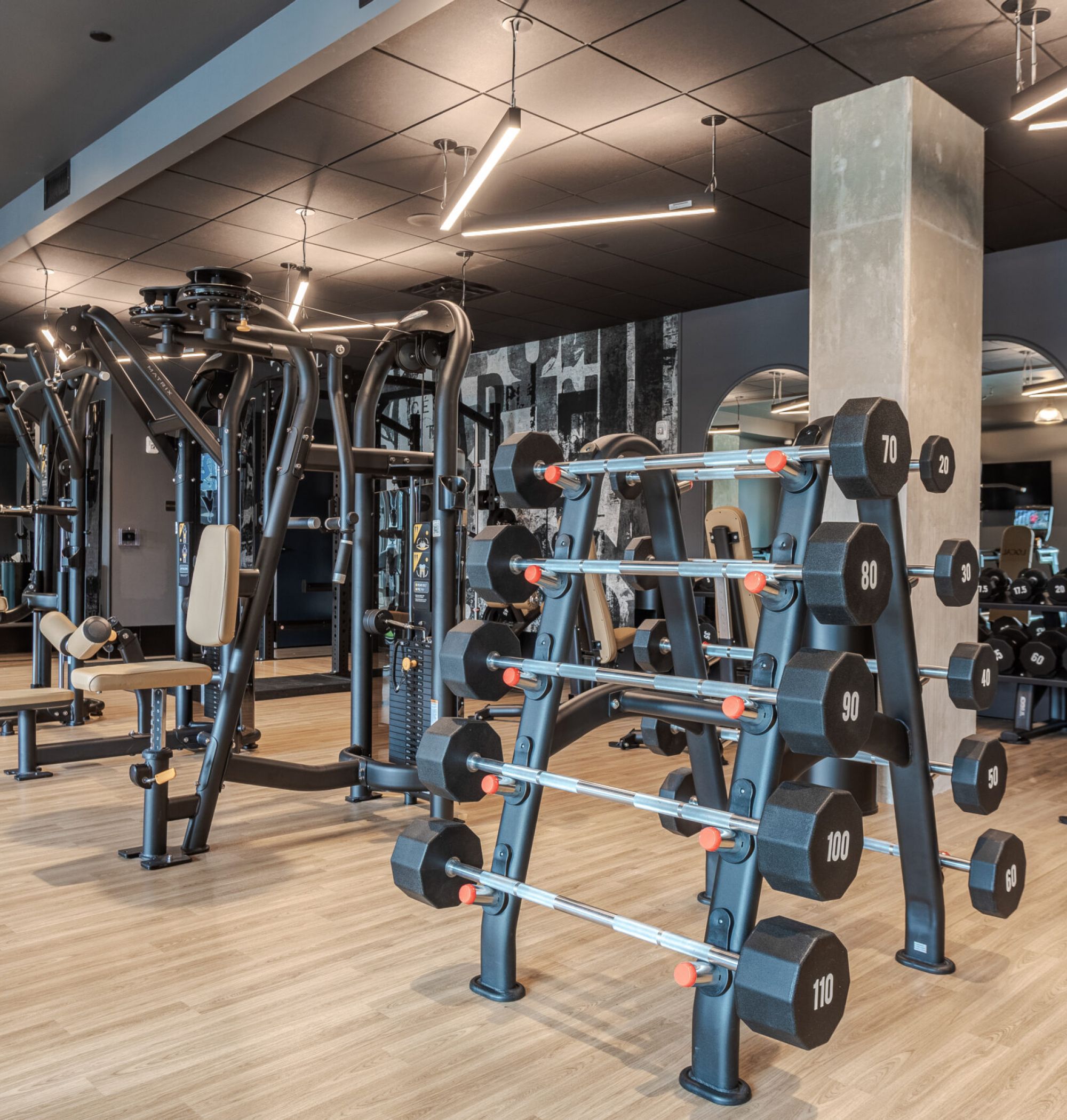 LOCAL Nashville Apartments fitness center rendering with turf flooring, state-of-the-art equipment, and modern lighting