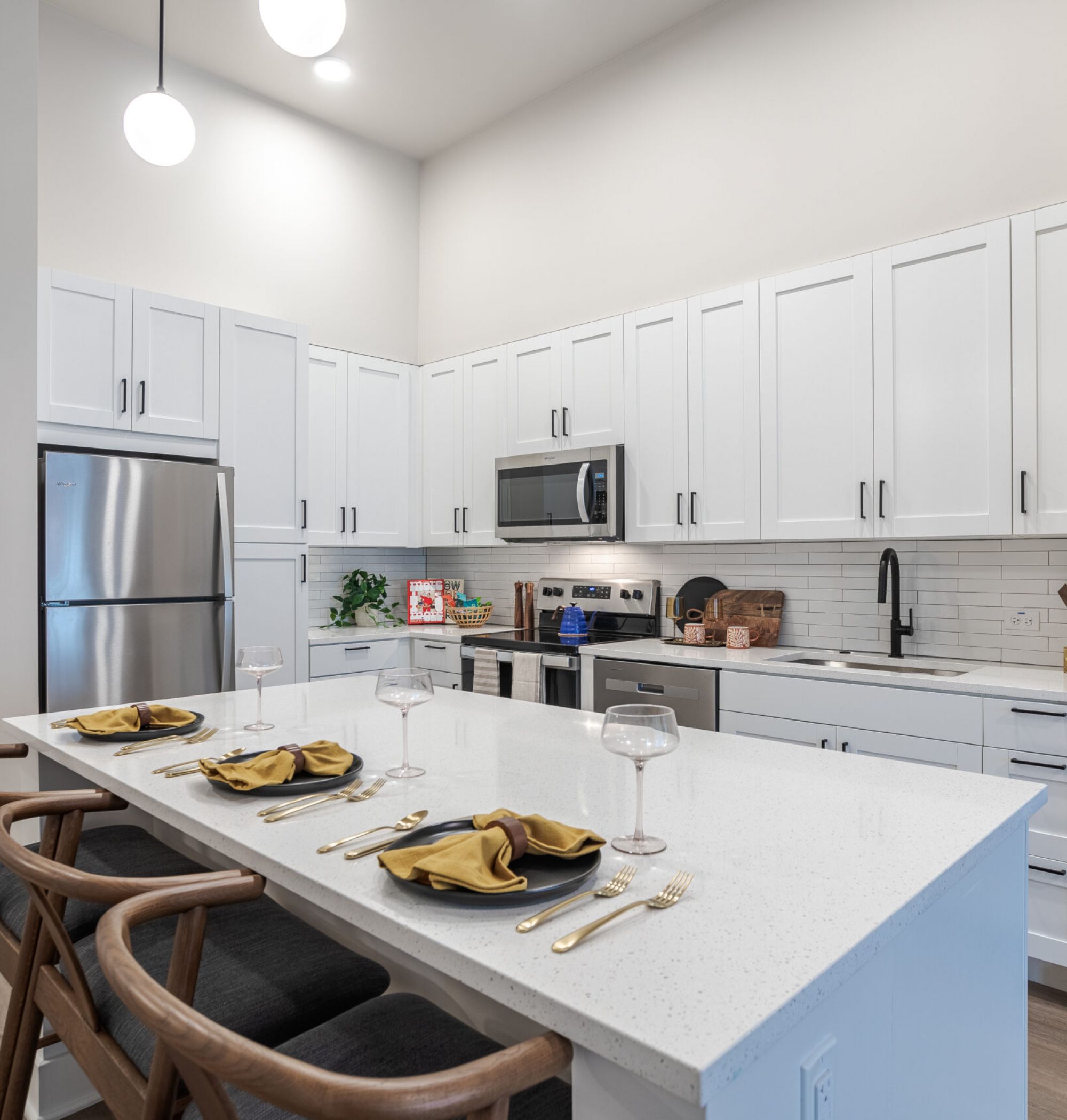 LOCAL Nashville Apartments bright kitchen with white cabinets, stainless steel appliances, and large kitchen island