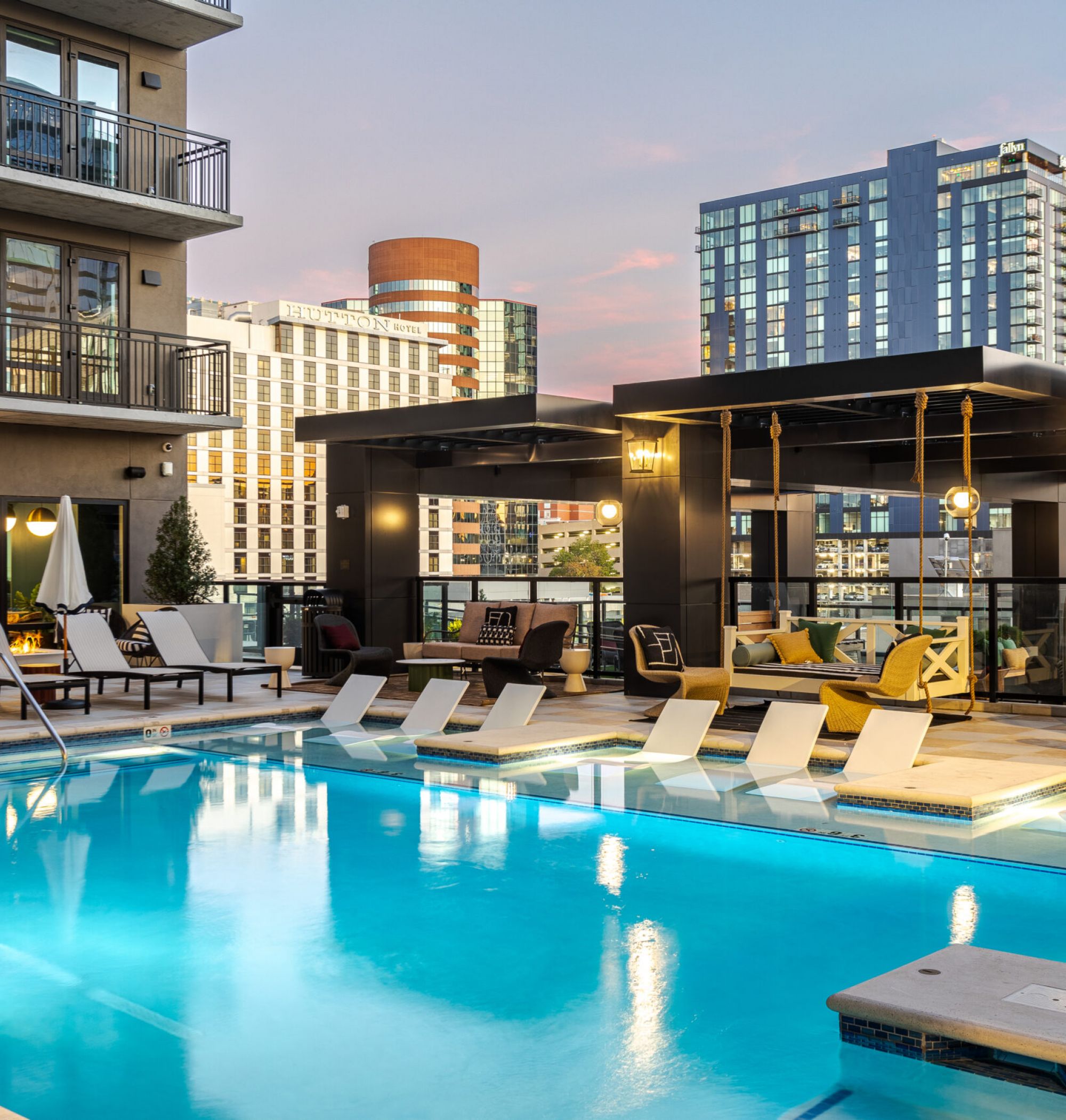 LOCAL Nashville Apartments outdoor pool with cabanas, fountains, and in-pool lounge chairs